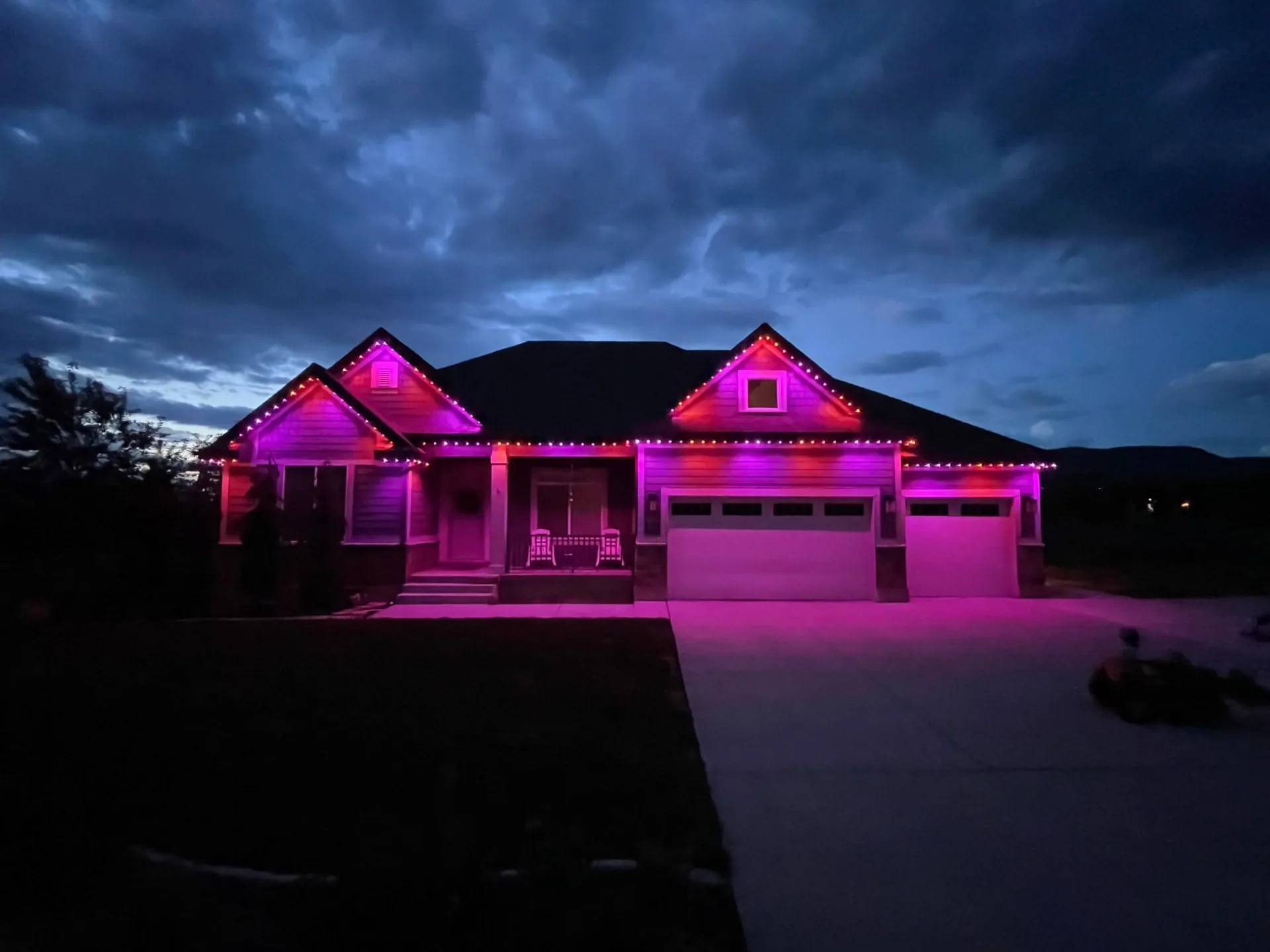 Home at dusk washed in pink and magenta light